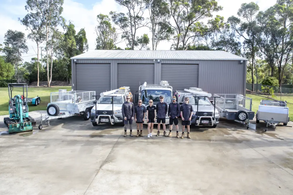 Liqwyd Solutions employees standing in front a shed and vehicles